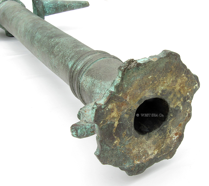 A pair of model cannons, German, circa 1700. Bronze barrels in several  sections with hoop structure and reinforced muzzles. Side mounted  trunnions. There are two sculpted hooks in the shape of dolphins